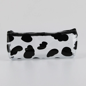 Macro shot of transparent PVC pencil case with black cow print and durable zipper detail
