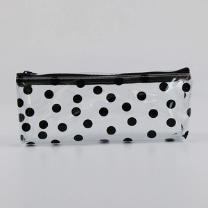 Macro detail of transparent PVC pencil case featuring stylish black polka dot pattern