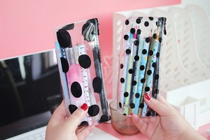 Close-up of transparent polka dot pencil cases showing large capacity for school stationery