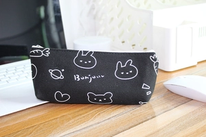 Detail of black canvas pencil case with cute white rabbit and cartoon planet prints