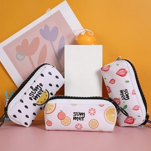 Detailed view of summer fruit pencil cases with watermelon and strawberry patterns