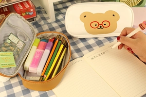 Detailed interior of a cute bear pencil case with mesh pocket and stationery storage