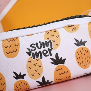 Detail of high-capacity pencil case with pineapple pattern and summer lettering text