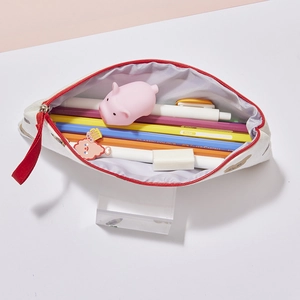 Detail view of large capacity cream bear pencil case with red zipper and cute cartoon print