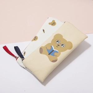 Detail of cream canvas pencil cases showing cute bear prints and durable metal zippers