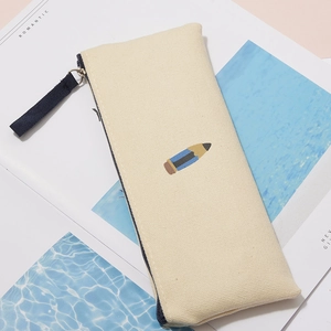 Close-up of beige canvas pencil case with cute pencil embroidery and zipper pull