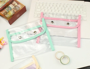 Flat lay of large capacity transparent PVC stationery bags with colored fabric edges