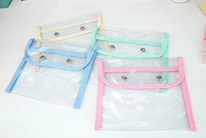 Detail view of large capacity transparent PVC stationery bags with snap button closure