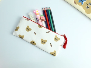 Detail of white canvas pencil case with red zipper and cute brown bear patterns