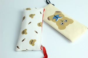 Close-up of cute bear printed canvas pencil case with vibrant zipper detail