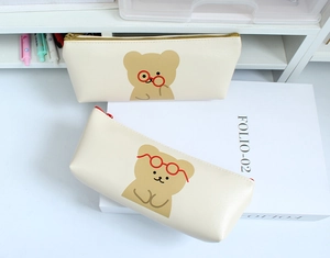Detail of cream pencil case with cartoon bear and high-quality gold and red zippers