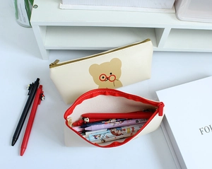Detail of cute bear pencil case showing large capacity storage with colorful pens inside
