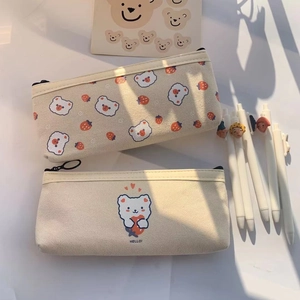 Detail of two cute bear canvas pencil cases with floral prints and large capacity