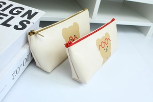 Detail of cream PU leather pencil cases with cute bear prints and metal zipper closures