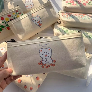 Close-up of cute bear canvas pencil case with strawberry patterns and zipper detail