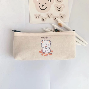 Close-up of cute bear and strawberry canvas pencil case with zipper and fabric texture