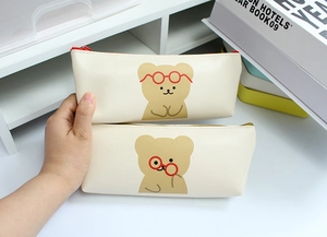 Close-up of cute cartoon bear pencil cases with detailed zipper and PU leather texture