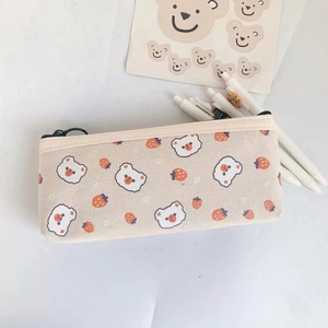 Close-up of cream canvas pencil case featuring cute bear and strawberry prints
