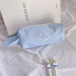 Detail of light blue canvas pencil case with smile pattern and cartoon cloud pens