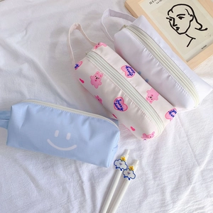 Detailed close-up of high-capacity zipper pencil cases with cute bear and smiley prints