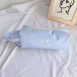 Light blue minimalist canvas pencil case with smiling face and side handle strap