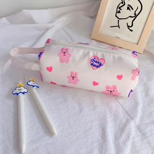 Detail of a large pink fabric pencil case with bear patterns and a side handle strap