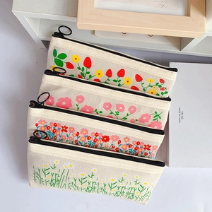 Set of four floral canvas pencil cases with daisy and strawberry prints for students