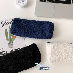 Rear view of fuzzy teddy fleece cherry stationery bags in navy blue and cream white