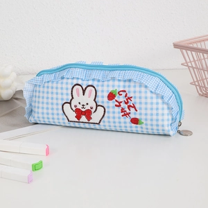 Detail of blue plaid pencil case with cute rabbit embroidery and ruffle zip trim