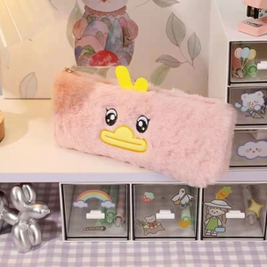 Detail view of the soft pink plush pencil case featuring cute duck embroidery and gold zipper