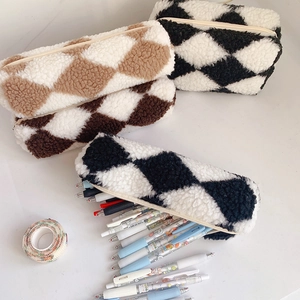 Macro shot of plush checkered pencil case with zipper closure and spacious interior