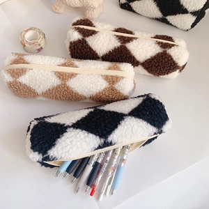 Close-up of checkered plush canvas pencil cases showing soft texture and metal zippers