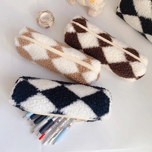 Close-up of plush quilted pencil cases in khaki and brown with soft lamb wool texture