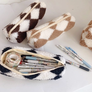 Three plush checkered pencil cases in brown, coffee, and blue with soft fleece texture