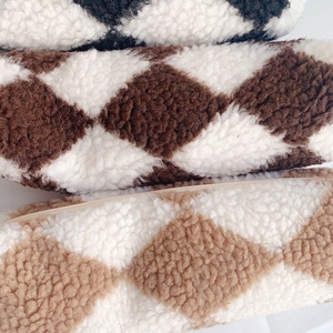 Quilted fleece pencil cases in black, brown, and cream with soft lamb wool texture