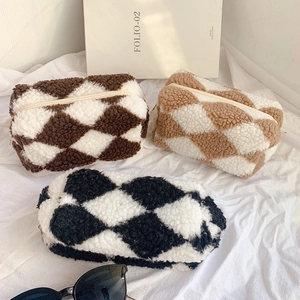 Checkered plush sherpa stationery pouches in brown and black-white diamond patterns