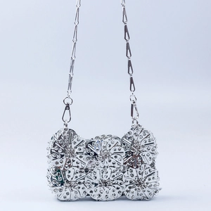 Silver handmade metal flower chain crossbody bag with intricate hollowed circular plates