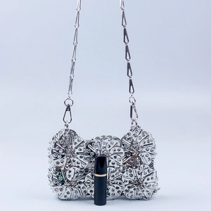 Handcrafted silver floral petal metal clutch bag with unique chain strap and polished finish