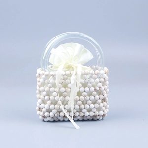 Elegant beaded handbag with marble pattern beads, satin liner, and clear acrylic handles