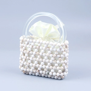 Detail of beaded handbag with marble texture beads and clear acrylic D-shape handles