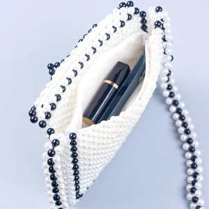 Handmade pearl beaded envelope crossbody bag with black and white stripes and shoulder strap