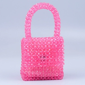 Detailed view of handmade pink acrylic beaded handbag with square flap and rounded handle