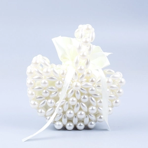 Handcrafted pearl woven handbag with floral pattern and white satin drawstring inner pouch
