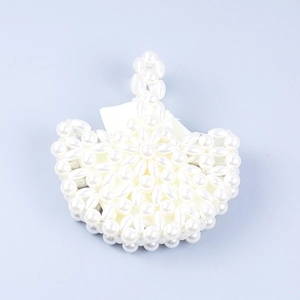 Detailed close-up of handmade faux pearl woven pattern on a fan-shaped evening handbag