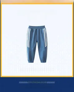 Detail of blue boys sports trousers with white side stripes and elastic waistband