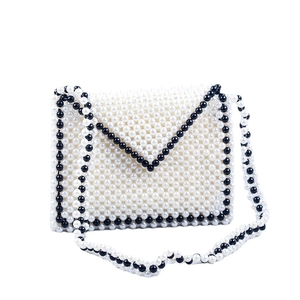 Handmade woven faux pearl envelope crossbody bag with black and white beaded detailing