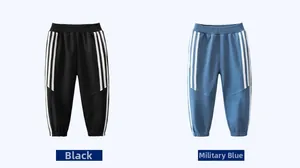 Flat lay of boys' black and military blue joggers with side stripes and elastic waist