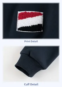 Detail showing red towel embroidery patch and elastic ribbed cuffs on navy blue sweatshirt
