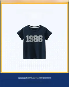 Detail of boys dark blue cotton t-shirt featuring grey stitched 1986 number print