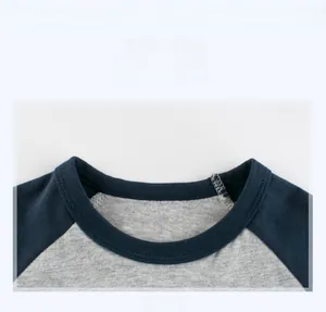 Detail show of the reinforced crew neck and raglan sleeve stitching on the kids' T-shirt